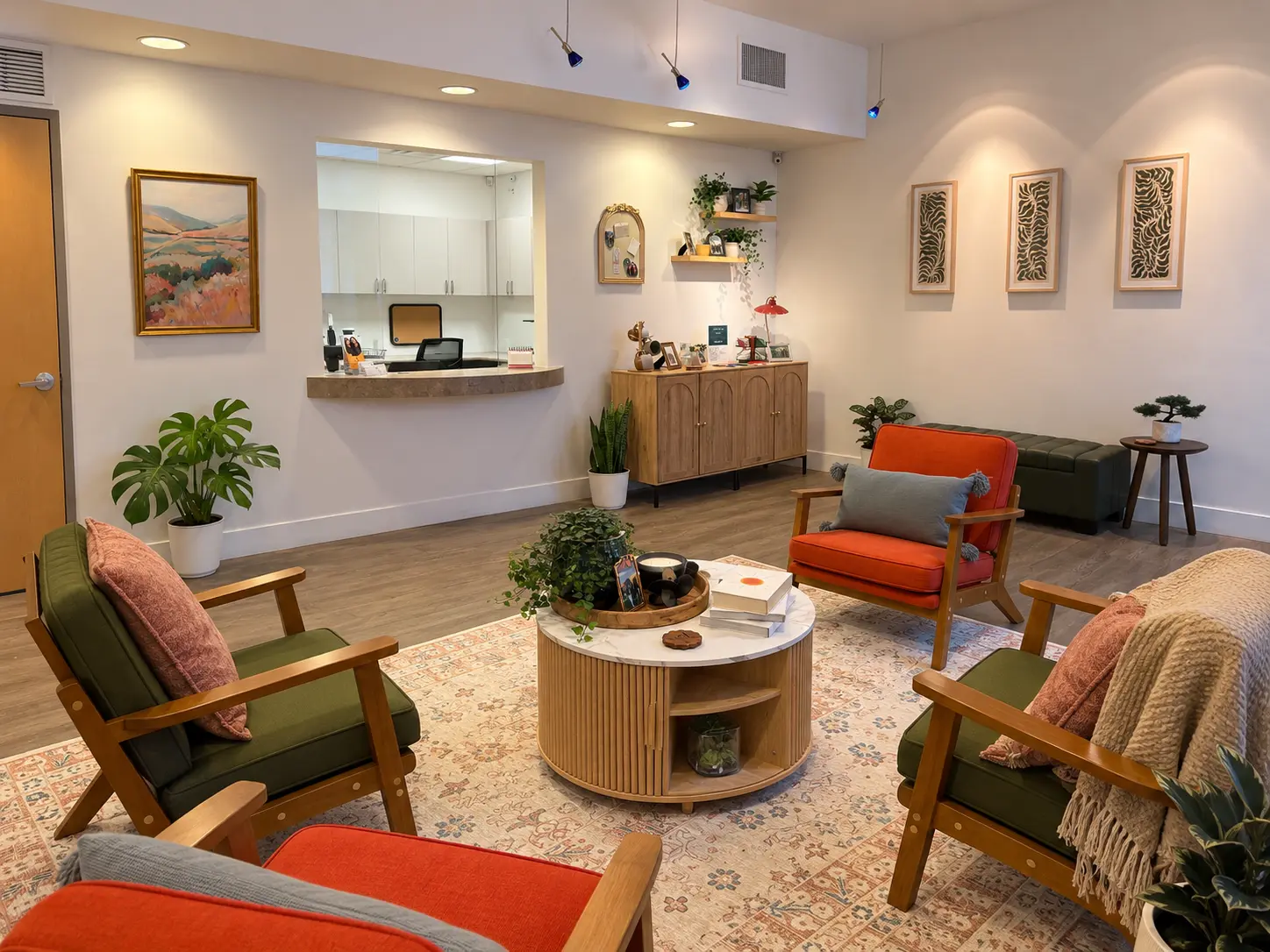 The clinic reception area with colorful chairs, plants, and a round coffee table