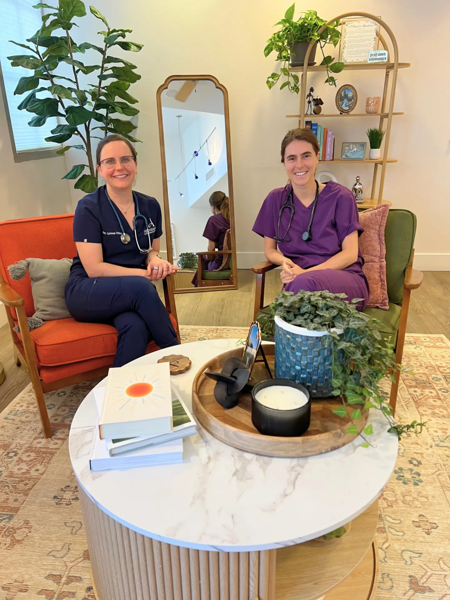 Dr. Lynnea Felton, NMD and Dr. Leah Gusching, NMD seated together in the Abundance Naturopathic Medicine clinic