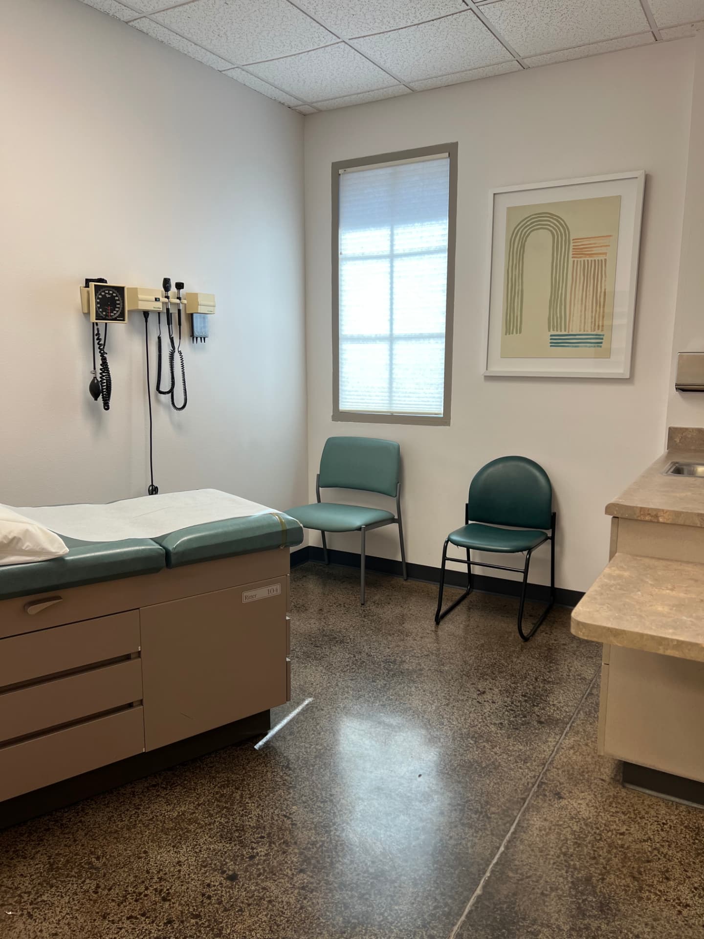 An Abundance examination room with a treatment table and comfortable chair